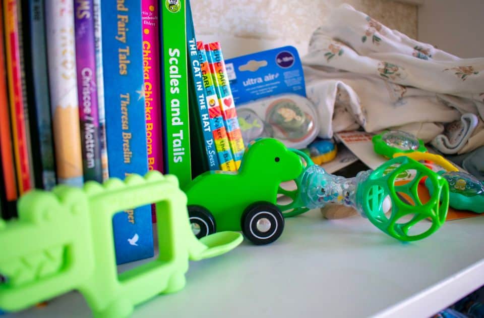 A shelf of baby toys and books
